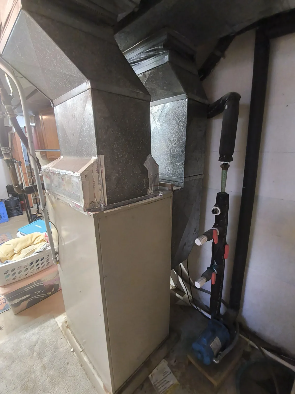 Older forced-air furnace before a geothermal conversion in Dayton, MN