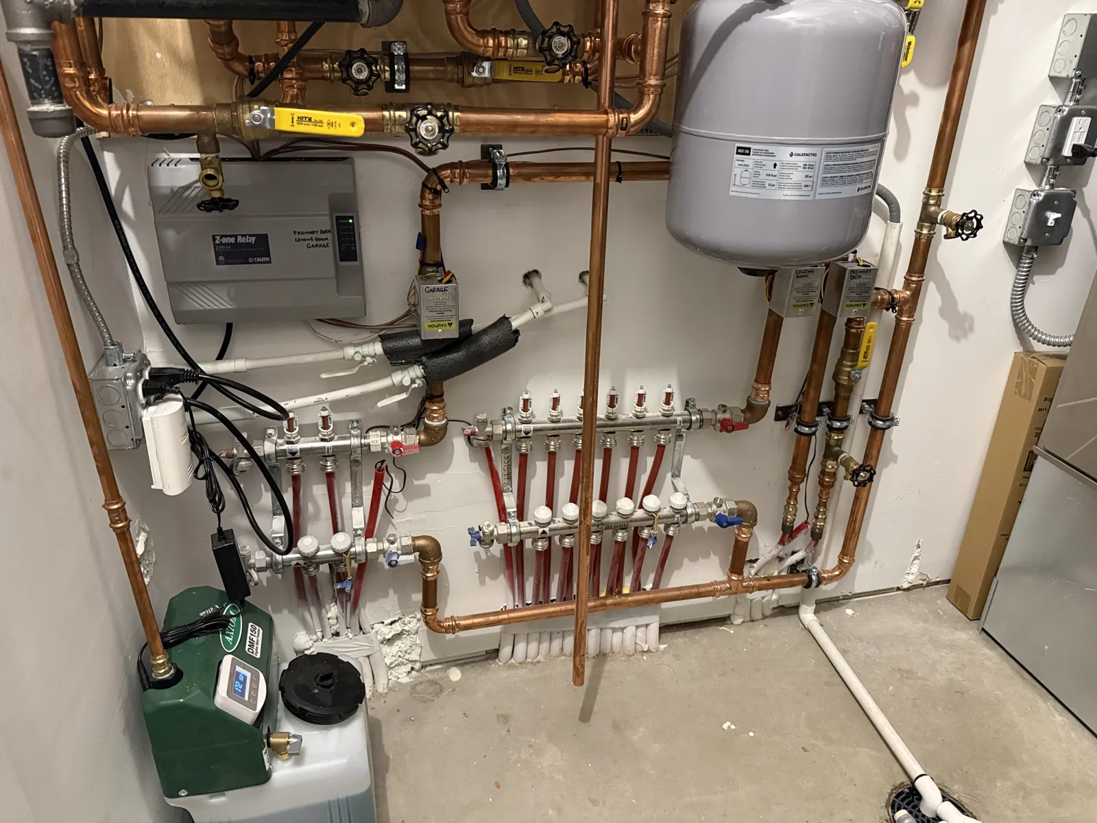 Radiant floor heating manifolds and zone control piping in a Waconia, MN mechanical room